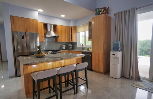 Antoneys Cay Villa | Enchanting blend of sea views and lush green hillside panoramas.
