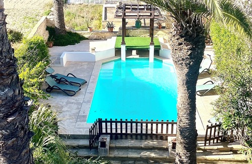 Gharb House | Enchanting converted farmhouse with private pool and mature garden with seaviews
