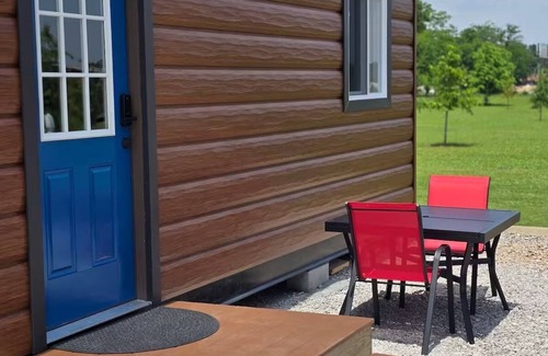 Tuscumbia Cabin | Enjoy cabin #65 at Heritage Acres Park with swimming, splash pad & more!