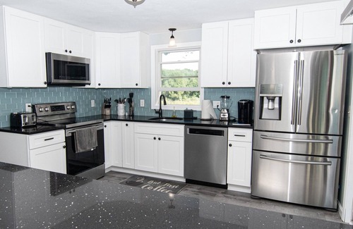 Saunderstown House | Enjoy the deck with pond view! Great Location, Rt 1A. 4 BR-all Queens, 2.5 Bath