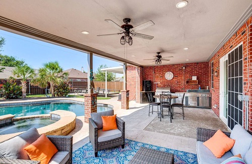 Rowlett House | Enjoy the peace and quiet back patio with Lagoon pool.