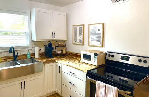 Mena Cottage | Experience History in an original Carriage House located behind a Colonial home.