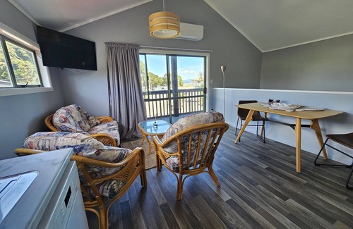 Maketu Apartment | Family room, come and enjoy the magical sunset on the balcony, Pet Friendly
