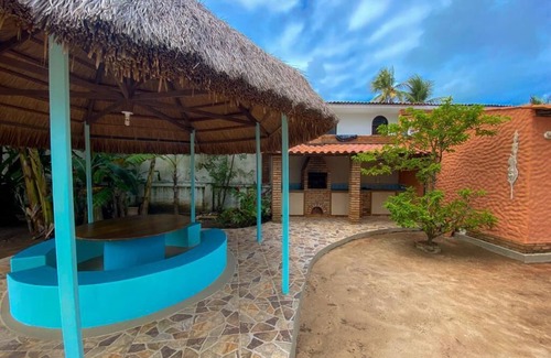 Petropolis Ski Chalet | Feet in the sand at Garça beach in Maceió-AL