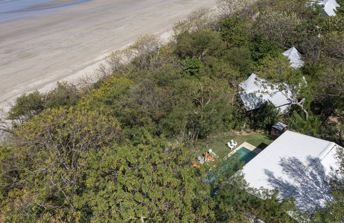 Playa Grande House | Five Bungalows, Swimming Pool and Amenities Amidst a Beachfront Forest.