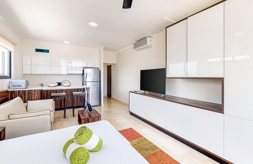 Zama Apartment | Fourth-floor studio with rooftop pool, partial A/C, city views, & balcony