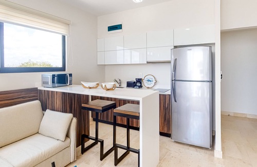 Zama Apartment | Fourth-floor studio with rooftop pool, partial A/C, city views, & balcony