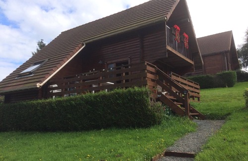Saint-Germain-de-Tallevende-la-Lande-Vaumont Ski Chalet | Traditional Log Cabin on quiet Residential Commune overlooking Lake Dathee