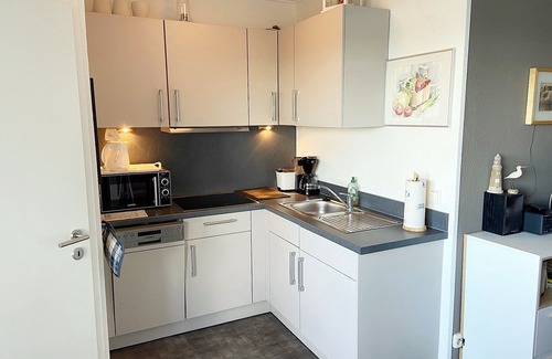 Heiligenhafen Apartment | Friendly and renovated apartment with laminate flooring on the 14th floor.