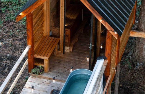 Armstrong House | Glamping in the woods with this Treehouse built in between 2 big alive Fir Tree