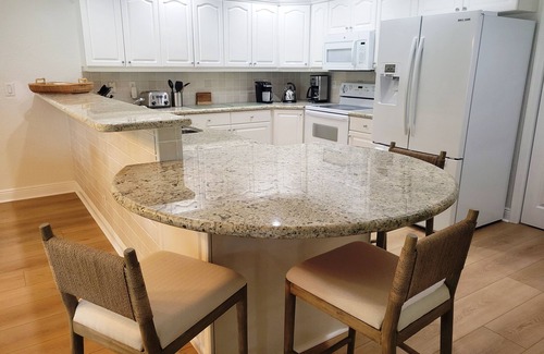 Wellington House | Golf cart distance to WEF! Charming 3 bedroom waterfront home with heated pool.