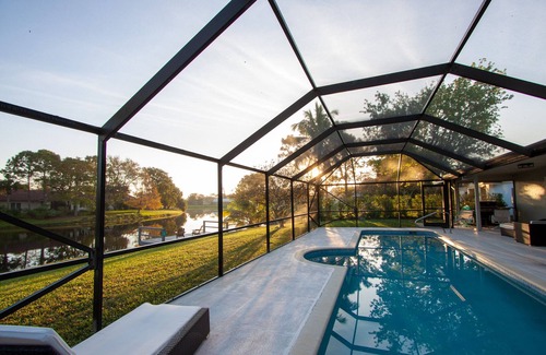 Wellington House | Golf cart distance to WEF! Charming 3 bedroom waterfront home with heated pool.
