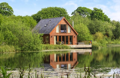 Menai Bridge Ski Chalet | Ground floor: Spacious open plan lounge, kitchen, dining area with log burner.