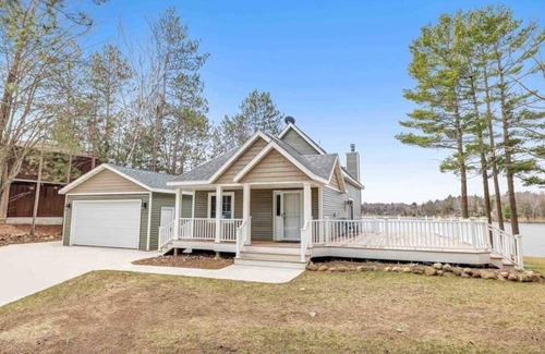 Krakow House | Highlights: Private beach just steps from your door Includes kayaks for exploring the lake Great fishing right off the shoreline or dock Bring your boat and enjoy full boating access Cozy indoor fireplace for cool evenings 4 spaciou