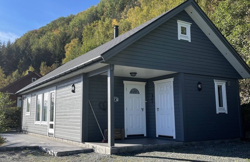 Hareid Cabin | Holiday home with view plot beyond Fjord and mountains.