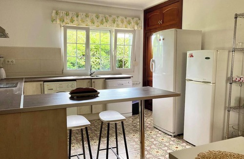 Aviles House | Homerez - Charming House in Bastian, Garden