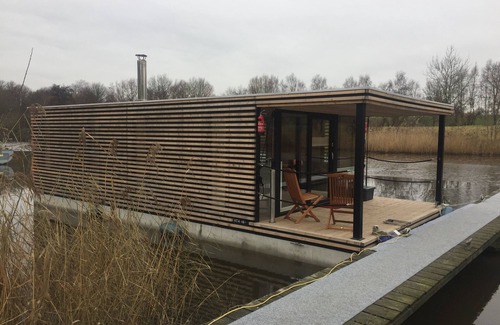 Rustersiel Boat Rental | Houseboat HT 4; with fireplace for 4 people in an idyllic location in Wilhelmshaven