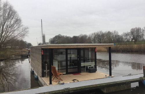 Rustersiel Boat Rental | Houseboat HT 4; with fireplace for 4 people in an idyllic location in Wilhelmshaven