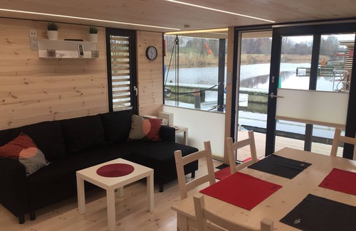 Rustersiel Boat Rental | Houseboat HT 4; with fireplace for 4 people in an idyllic location in Wilhelmshaven