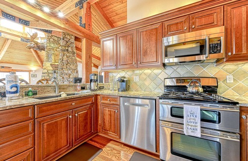 Louisa House | Huge lakefront home with A/C, sunroom, boat ramp, WIFI,game room, deck, & kayaks