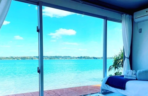 Nago Apartment | Indigo Ocean front Large windows overlook the se / Nago Okinawa