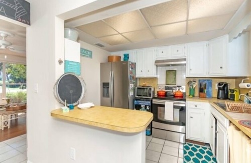 Oakland Hills House | Introducing Caddy Shack,the perfect abode for your short-term stay. This delightful 2 bed, 2 bath canal home has been thoughtfully remodeled to exude a beachy atmosphere