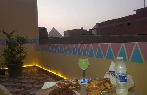 Giza House | It's a house .it has aquit roof with a view of pyramids