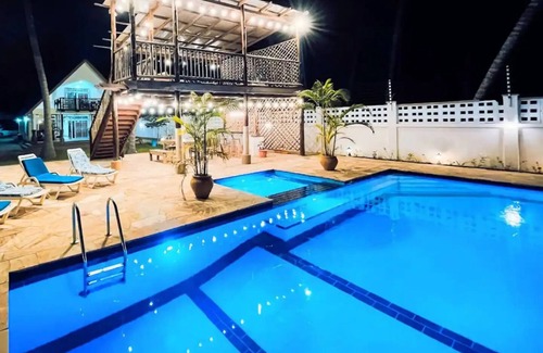 Upanga East Villa | Karibu Beach Villa - A private beach front home with a large pool and gardennn