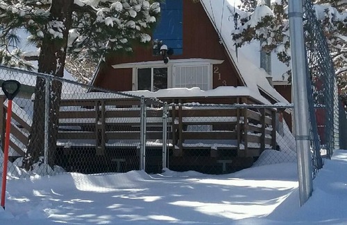 Woodlands Ski Chalet | Knotty Pine Chalet has a huge front deck and fully fenced yard .