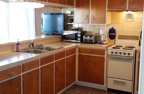 Gypsum House | Lake Front Nautical Themed Home with Private Yard & Sandy Bottom Water Access!