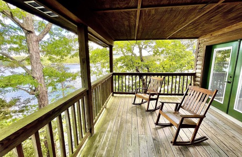 Mount Ida Cottage | Lake view three bedroom, three bath log-sided cottage with private hot tub overlooking Lake Ouachita. by RedAwning