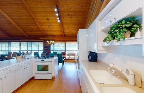 Bass Lake House | Lakefront home w/recreation room, hot tub, central AC, WiFi, private dock, & W/D