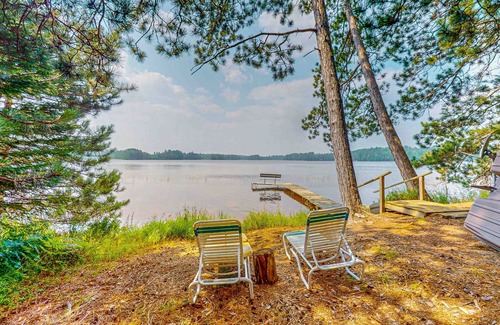 Eagle River House | Lakefront log cabin on Stone Lake w/2 docks, fire place, paddle boat, & WIFI