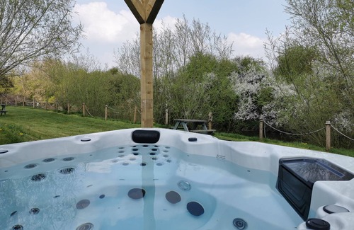 East Huntspill Apartment | Large three bedroom log cabin with private hot tub and decking over looking the beautiful river Brue