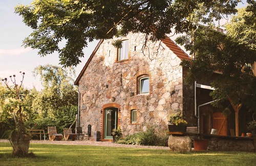 Klosterdorf House | Lovingly restored fieldstone barn with fireplace and woodchip heating.