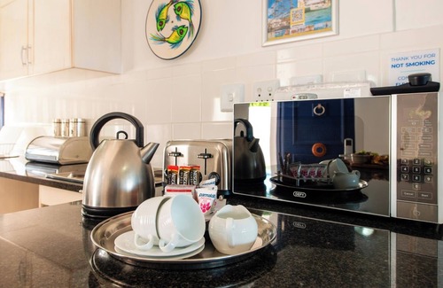 Mykonos Apartment | Luxe Beachside Retreat | Patio | Resort Perks