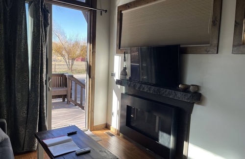 Montrose House | Luxury Accommodation. Bedroom with queen bed. Sleeper sofa in living area. Full bath with shower. Kitchen. Living area with TV and Fireplace. Washer/Dryer.