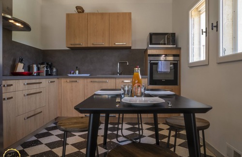 Paradou House | Mas Provençal first floor living room with fireplace and veranda overlooking Alpilles- Vallée des Baux
