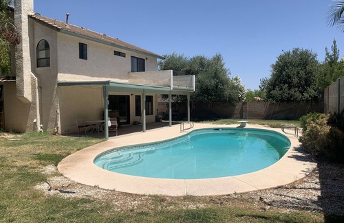 Paradise House | Master Bedroom and bath in a Vegas home with pool & 7 minutes to the stripn