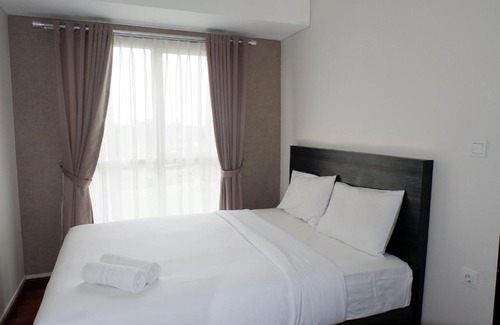 Pagedangan Apartment | Modern 1BR Casa De Parco Apartment By Travelio