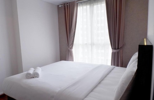 Pagedangan Apartment | Modern 1BR Casa De Parco Apartment By Travelio