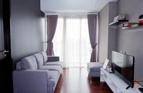 Pagedangan Apartment | Modern 1BR Casa De Parco Apartment By Travelio