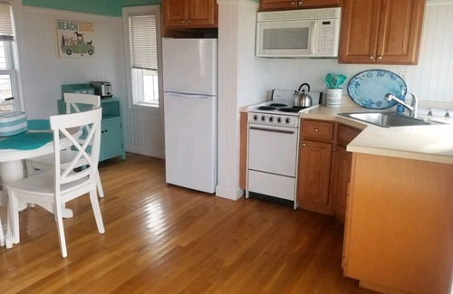 West Yarmouth Condo | Modern beachfront cottage newly renovated steps from warmest beach!