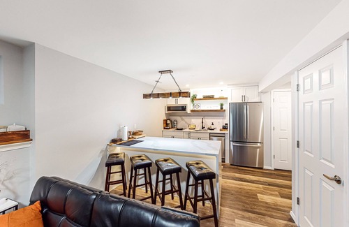 The Wedge House | Modern lower-level getaway with a fireplace, inviting patio & washer/dryer