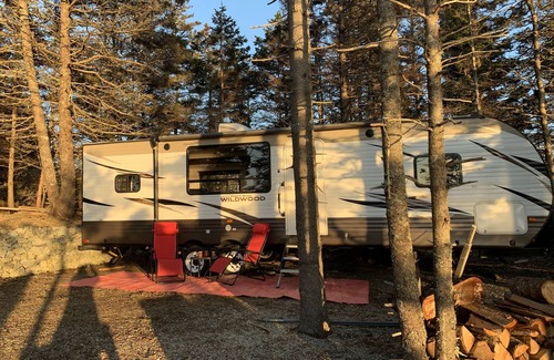 Clare House | Modern RV camper with all the perks nNestled in tree at lake edge