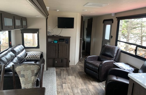 Clare House | Modern RV camper with all the perks nNestled in tree at lake edge
