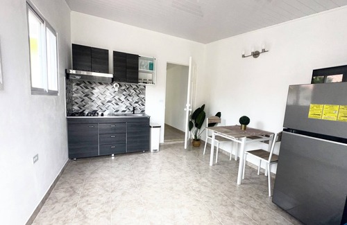 Oranjestad Apartment | New Modern 1B Apt Kitchen & TV