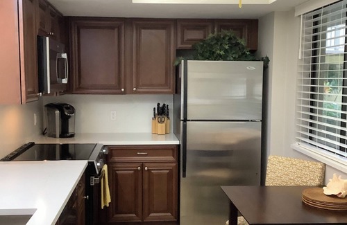 Bonita Bay Condo | Newly Renovated Corner Unit. Lake Views. Shuttle to Beach. Heated Pool/Spa
