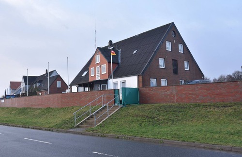 Neufeld House | Nordseehaus Op'n'Diek on the dike overlooking the small Priel harbor.