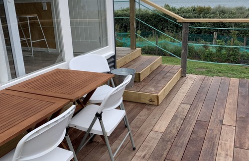 Cape Palliser House | Ocean views of the Kaikoura's and surf break. Private beach hut.